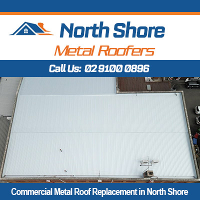 Commercial metal roof replacement in progress on North Shore building